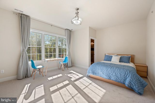 an aerial view of residential house with outdoor space and trees all around