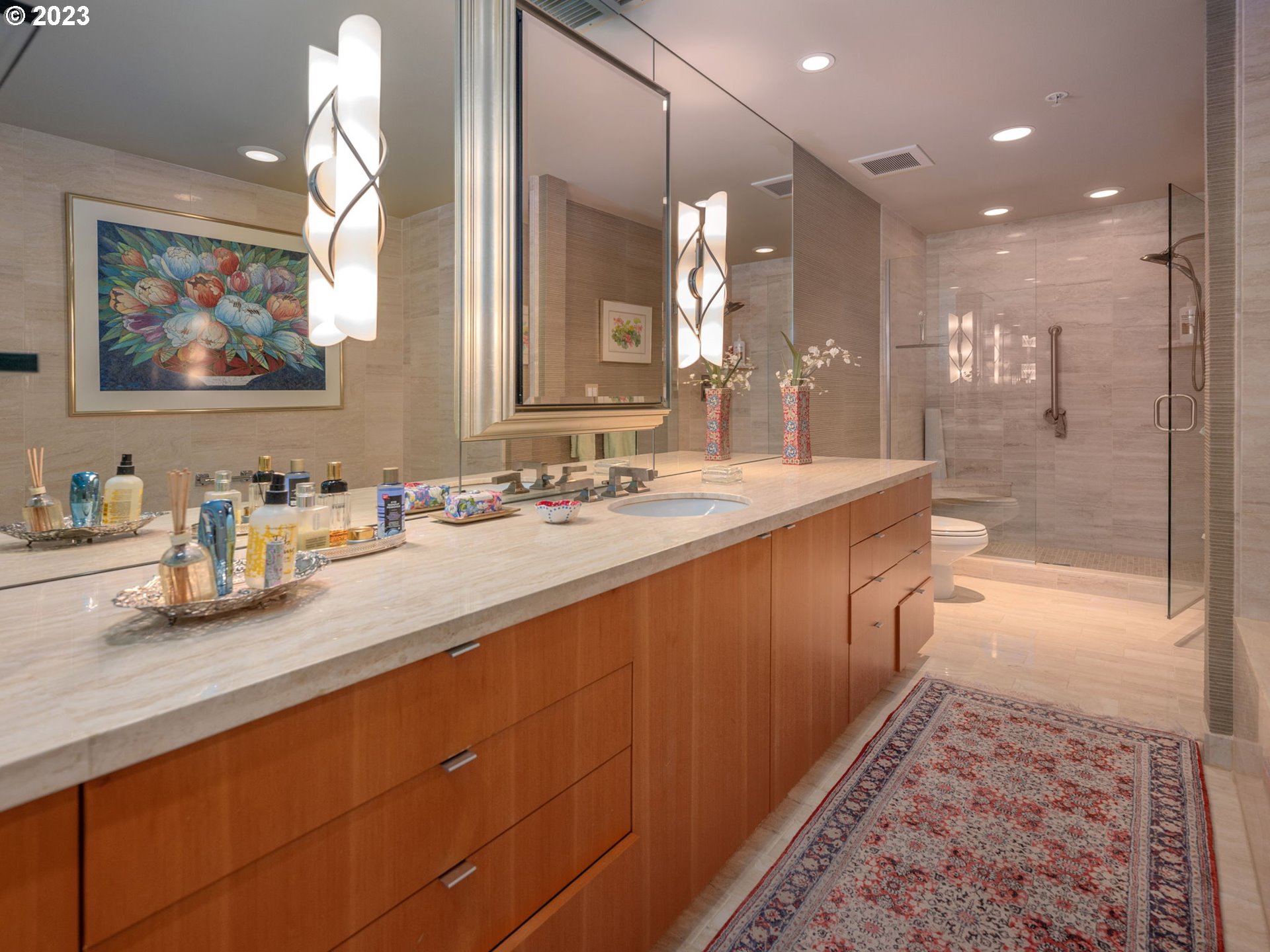 2445 Northwest Westover Road, Unit 411 Portland, OR 97210 - Photo 27 of 38 a bathroom with a double vanity sink mirror and shower