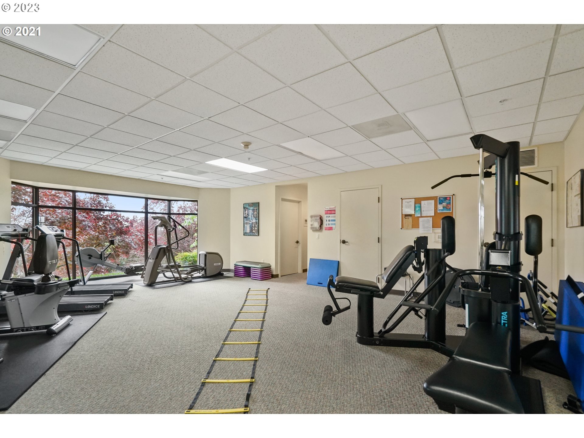 2445 Northwest Westover Road, Unit 411 Portland, OR 97210 - Photo 35 of 38 a living room with furniture a flat screen tv and a large window