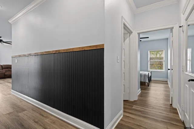 a view of a hallway with wooden floor
