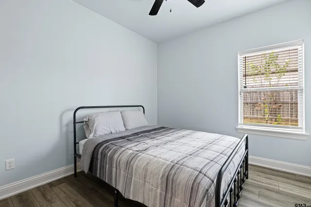 a bedroom with a bed and wooden floor