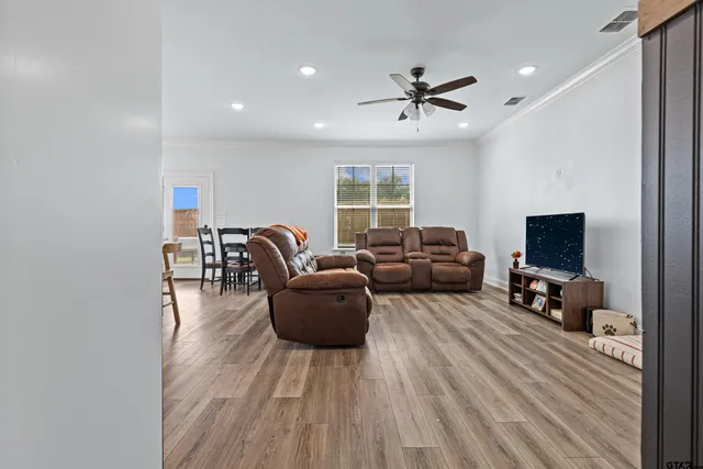 a living room with furniture and a flat screen tv