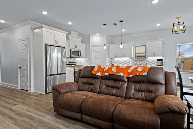a living room with furniture and kitchen view