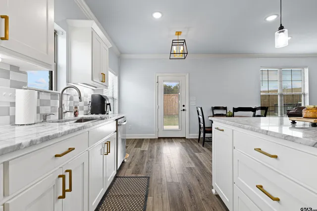 a kitchen with cabinets a sink and appliances