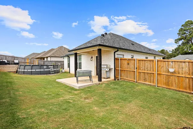 a view of a white house with a sink and a table and chairs