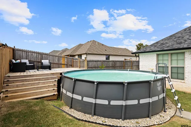 a view of a house with pool table and chairs