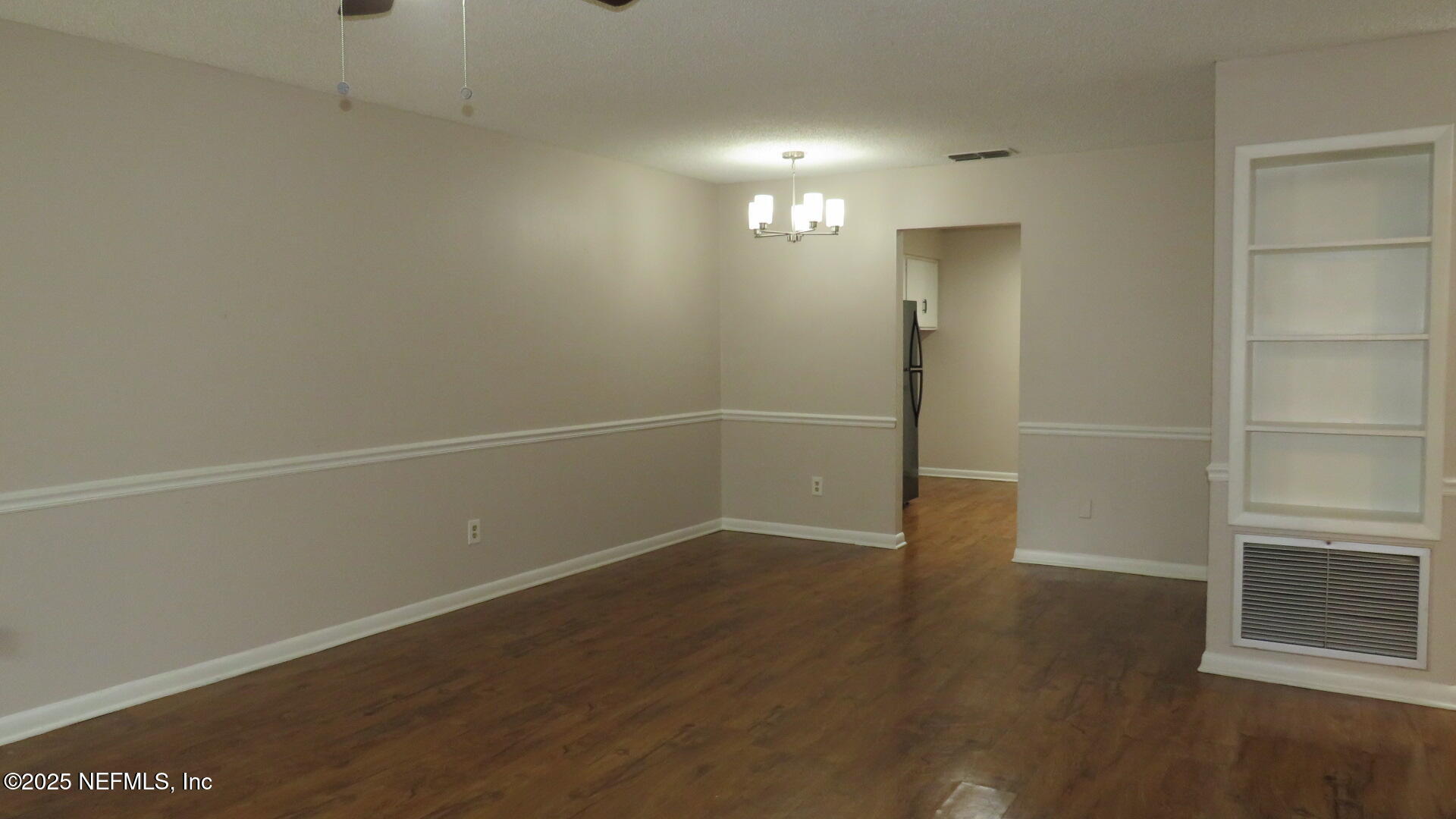 1160 Mohawk Street, Unit 2 Jacksonville, FL 32205 - Photo 2 of 9 a view of an empty room with wooden floor and a window