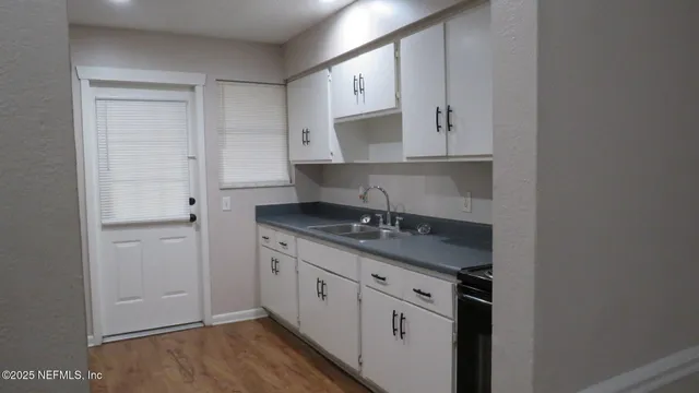 a kitchen with stainless steel appliances granite countertop a sink stove and cabinets