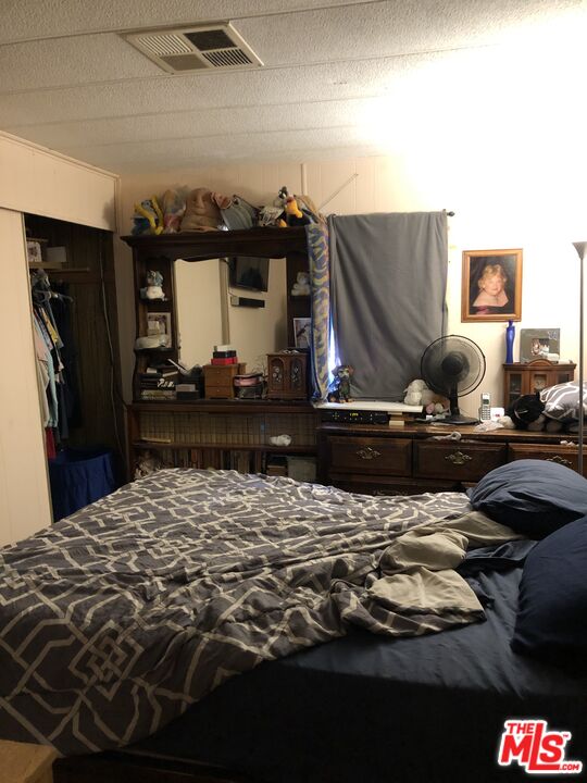 32886 Wildomar Trail Wildomar, CA 92595 - Photo 11 of 22 a bedroom with a bed and a dresser