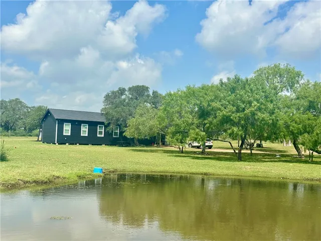 a view of a large building with a big yard and large trees