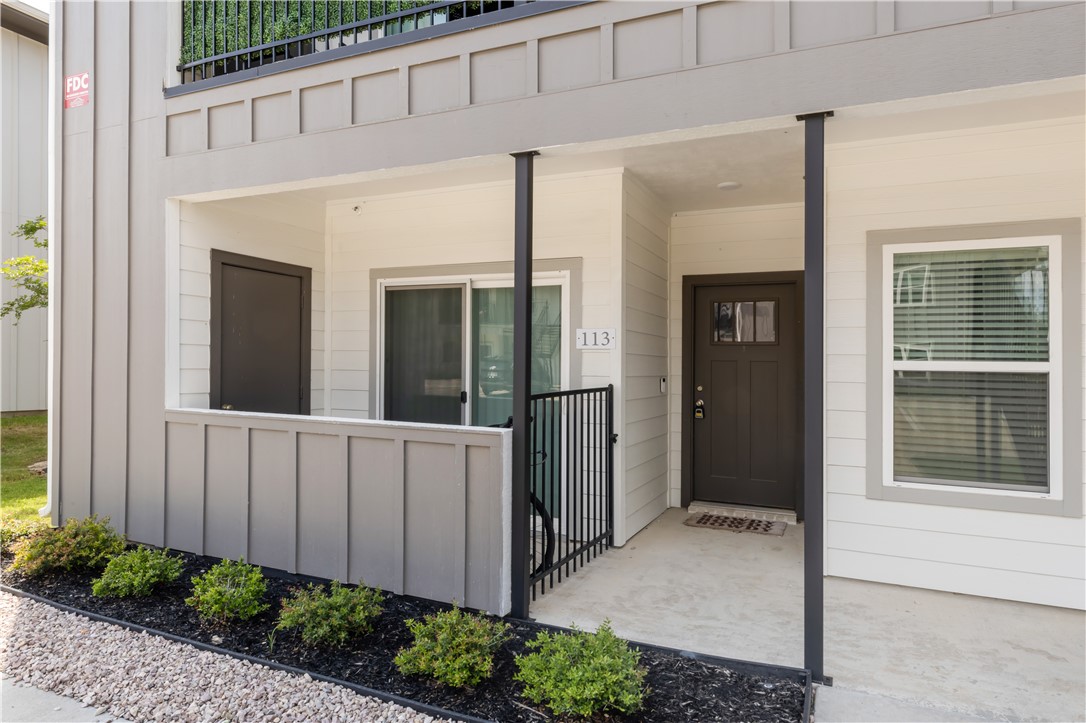 1326 Prairie Drive, Unit 113 Bryan, TX 77803 - Photo 2 of 21 View of exterior entry with board and batten sidin