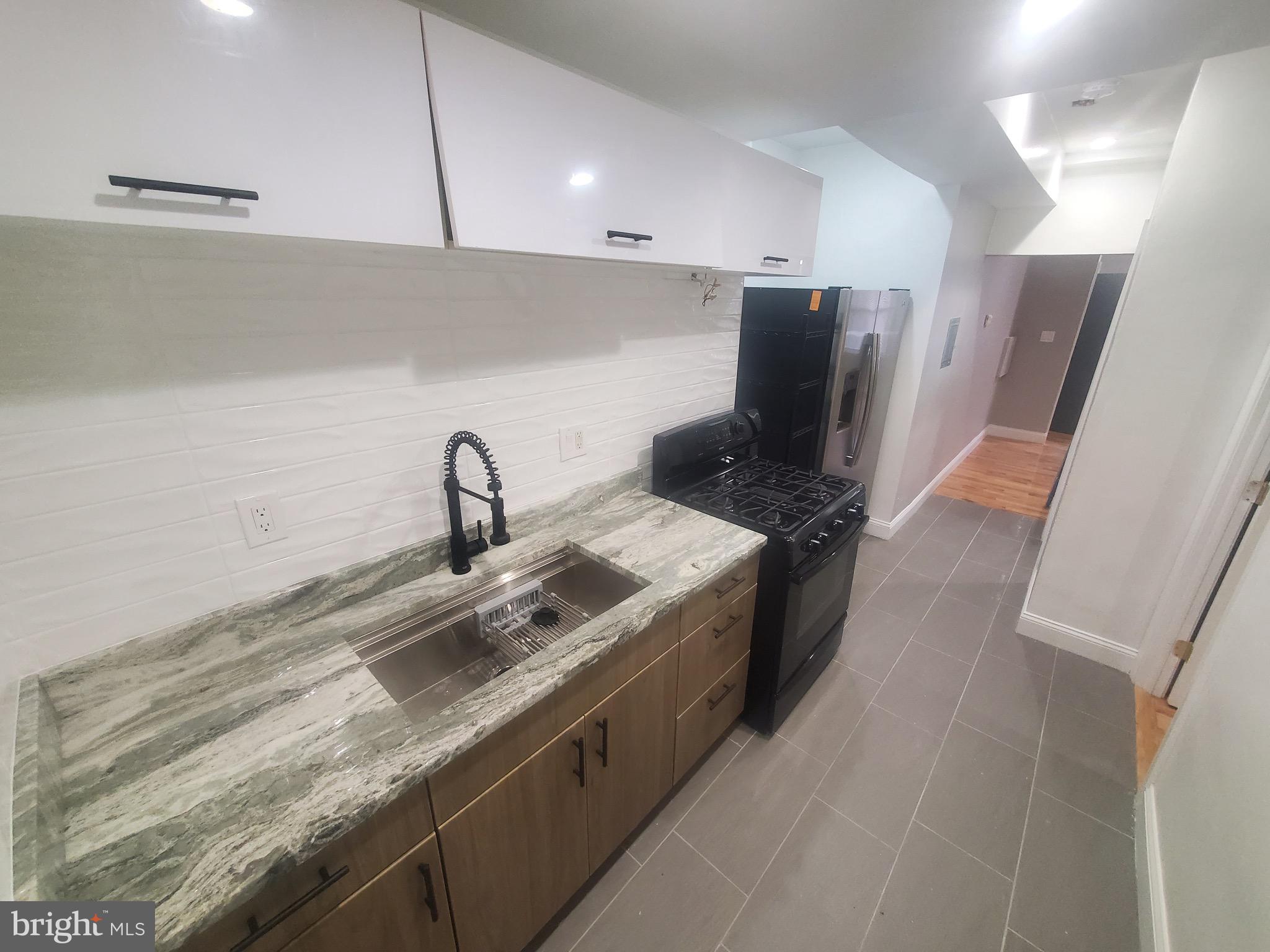 1122 Penn Street Northeast, Unit 1 Washington, DC 20002 - Photo 1 of 31 a kitchen with stainless steel appliances granite countertop a sink and a stove