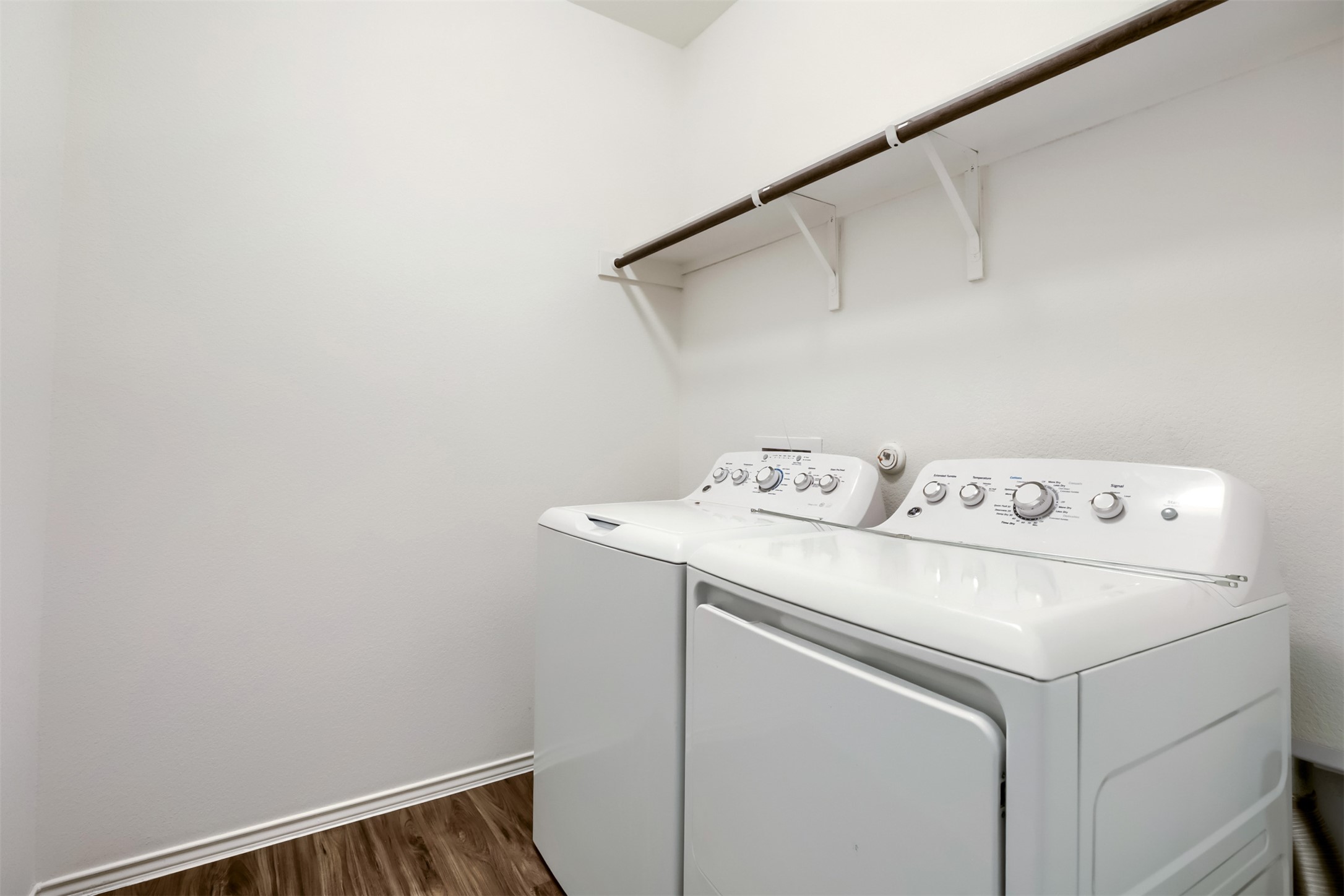 721 Mallow Road Leander, TX 78641 - Photo 19 of 22 Laundry area with a built-in shelf and wood-look flooring