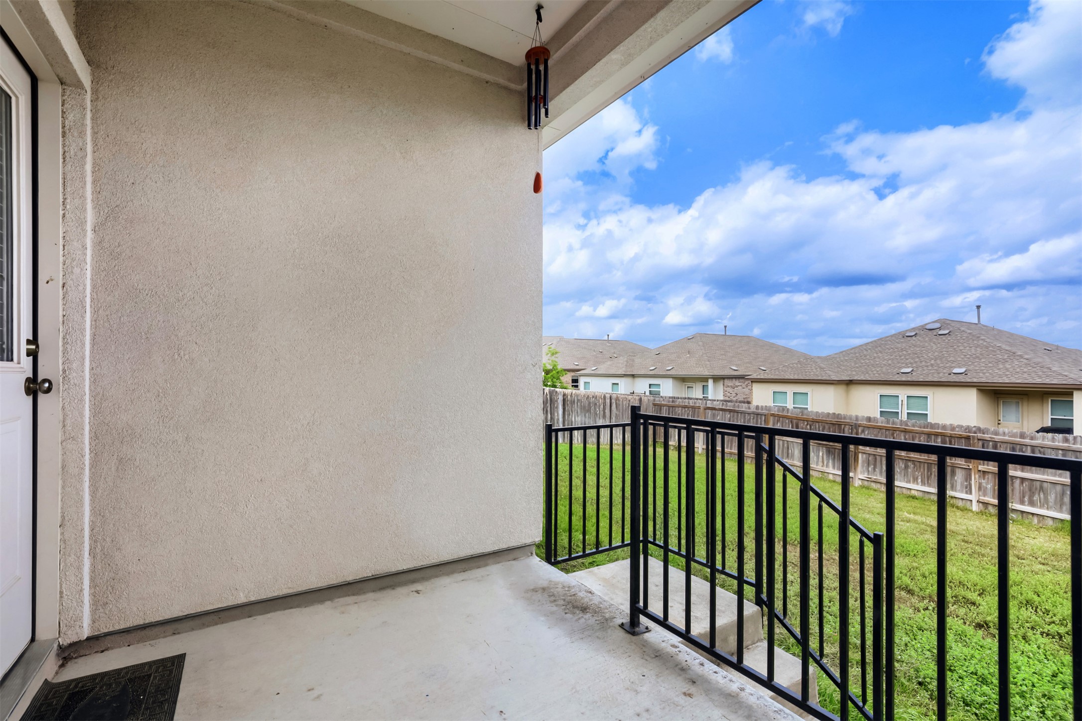 721 Mallow Road Leander, TX 78641 - Photo 20 of 22 Covered patio with a concrete floor, featuring a black metal railing and a view of the backyard