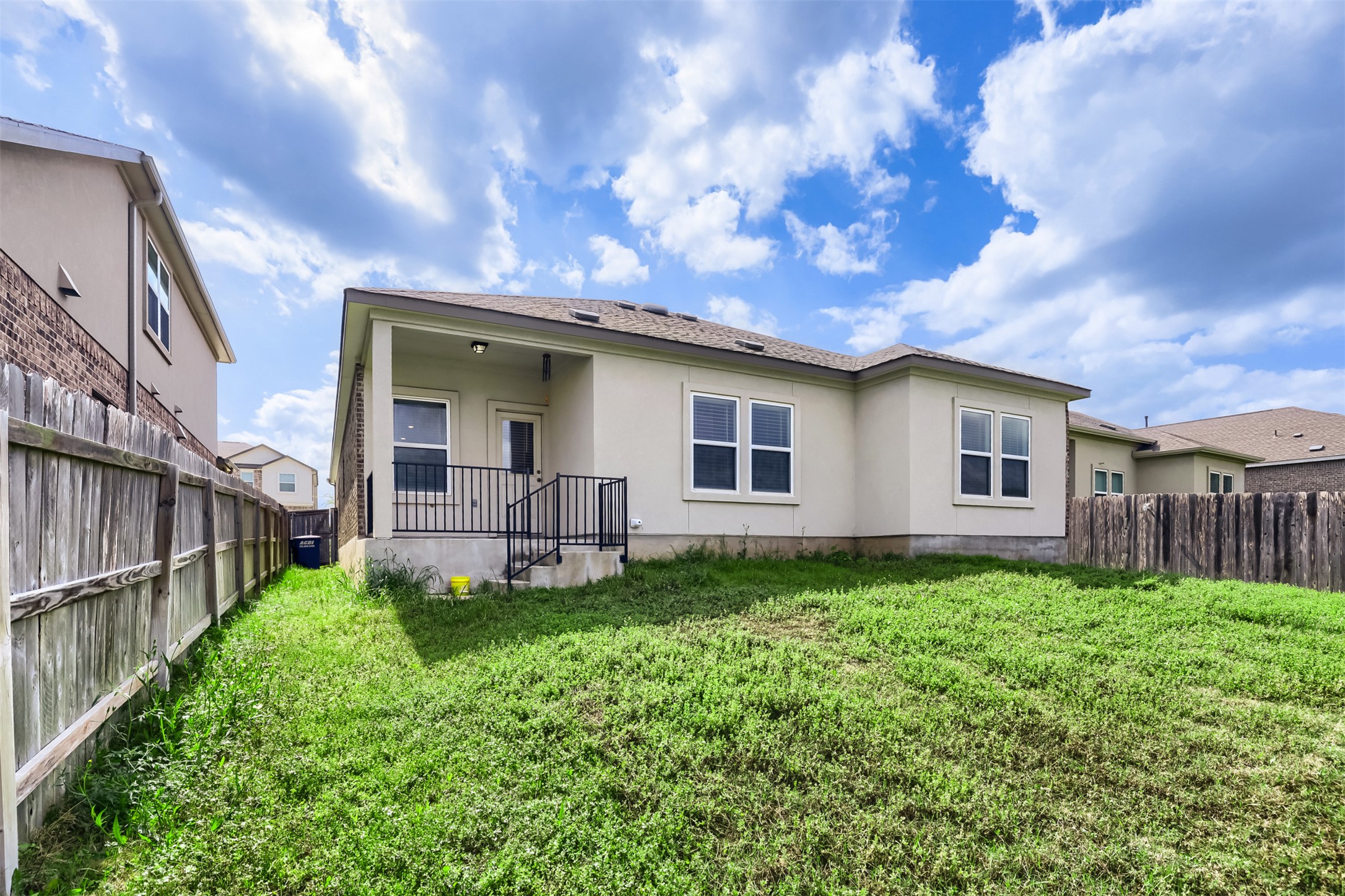 721 Mallow Road Leander, TX 78641 - Photo 22 of 22 The property features a private yard with a covered patio area and a grass lawn