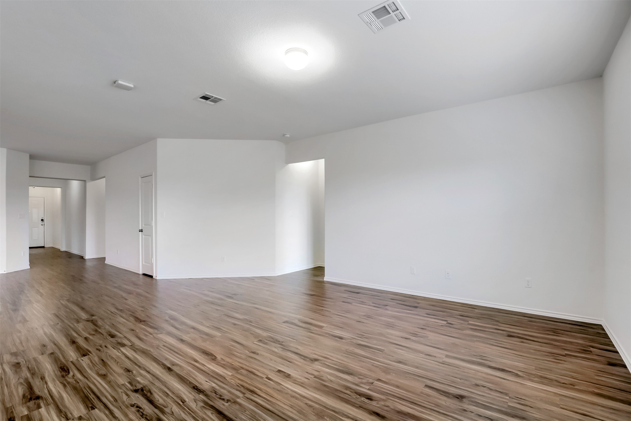 721 Mallow Road Leander, TX 78641 - Photo 5 of 22 The property features wood-style flooring and white walls, creating a bright and expansive interior
