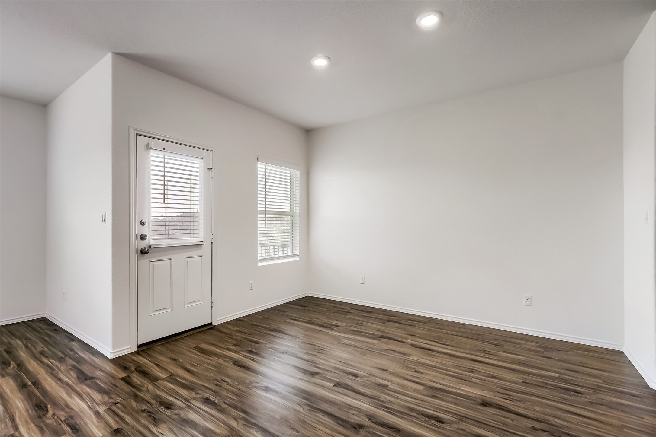 721 Mallow Road Leander, TX 78641 - Photo 6 of 22 Living area with wood-look flooring, recessed lighting, and a door with an inset window and blinds