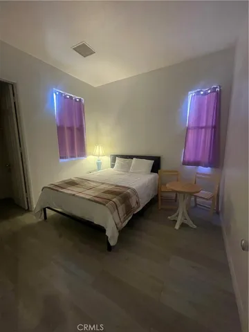 a bedroom with a bed and a mirror