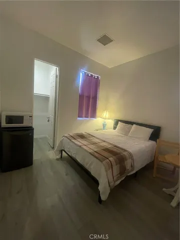 a bedroom with a bed and a view of bedroom