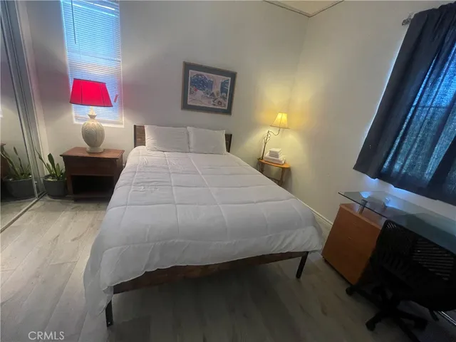 a bedroom with a bed and window