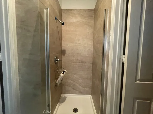 a bathroom with a shower and a sink
