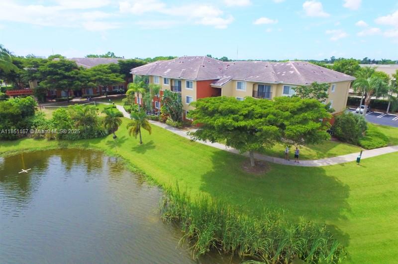 4149 Haverhill Road, Unit 1608 West Palm Beach, FL 33417 - Photo 13 of 29 a view of a lake with a house in the background