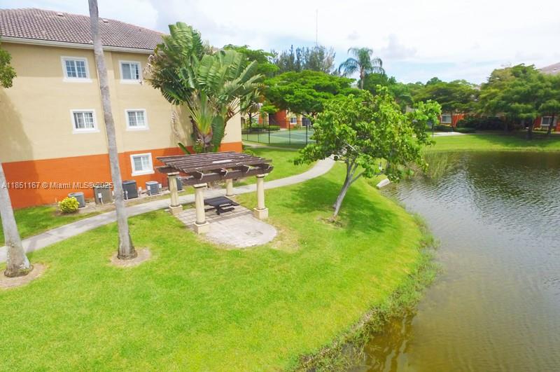 4149 Haverhill Road, Unit 1608 West Palm Beach, FL 33417 - Photo 15 of 29 a view of a swimming pool with a yard and plants