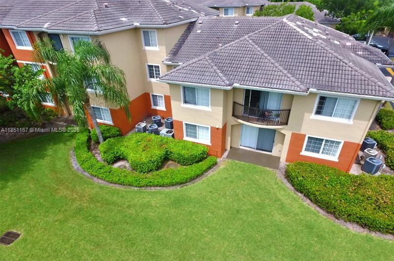 4149 Haverhill Road, Unit 1608 West Palm Beach, FL 33417 - Photo 16 of 29 a front view of a house with a garden and plants