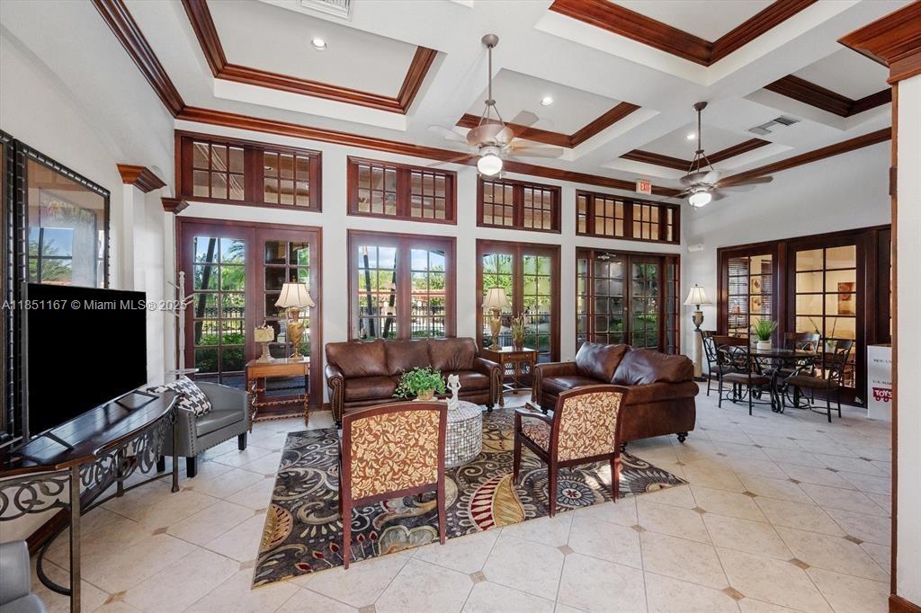 4149 Haverhill Road, Unit 1608 West Palm Beach, FL 33417 - Photo 21 of 29 a living room with patio furniture and a flat screen tv