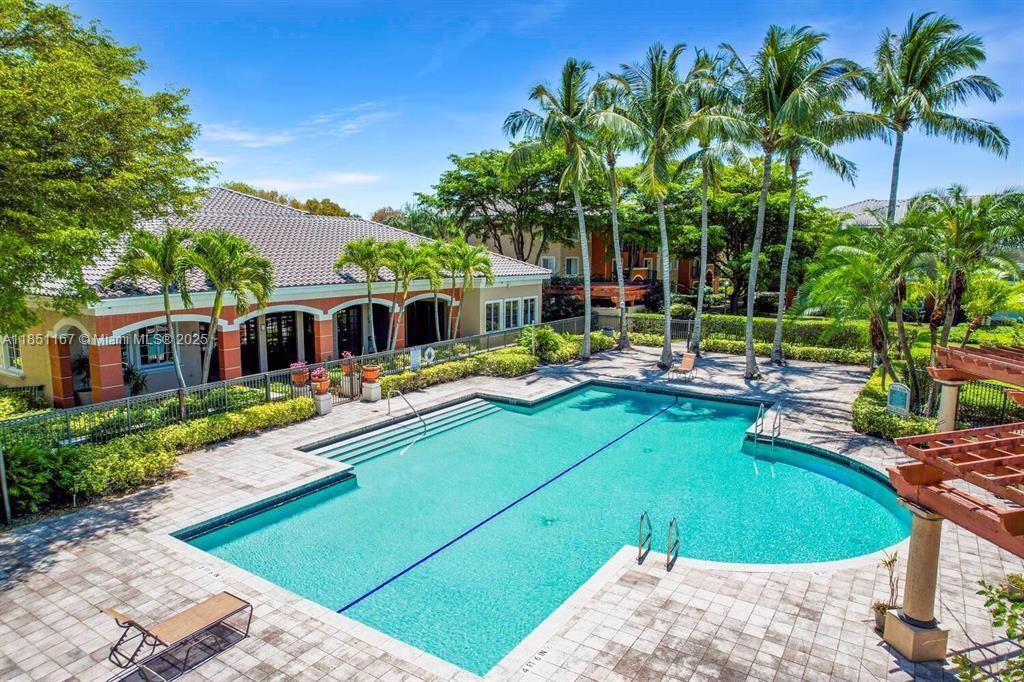 4149 Haverhill Road, Unit 1608 West Palm Beach, FL 33417 - Photo 23 of 29 a swimming pool with outdoor seating and yard