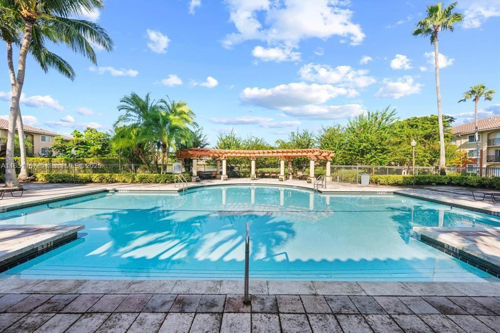 4149 Haverhill Road, Unit 1608 West Palm Beach, FL 33417 - Photo 24 of 29 a view of a swimming pool with a lounge chairs
