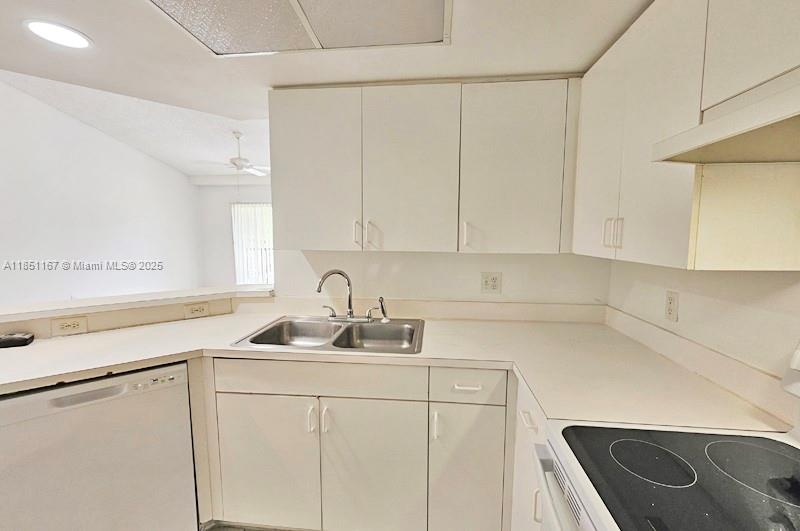 4149 Haverhill Road, Unit 1608 West Palm Beach, FL 33417 - Photo 5 of 29 a kitchen with stainless steel appliances white cabinets and a sink