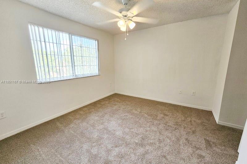 4149 Haverhill Road, Unit 1608 West Palm Beach, FL 33417 - Photo 7 of 29 an empty room with a window and a fan
