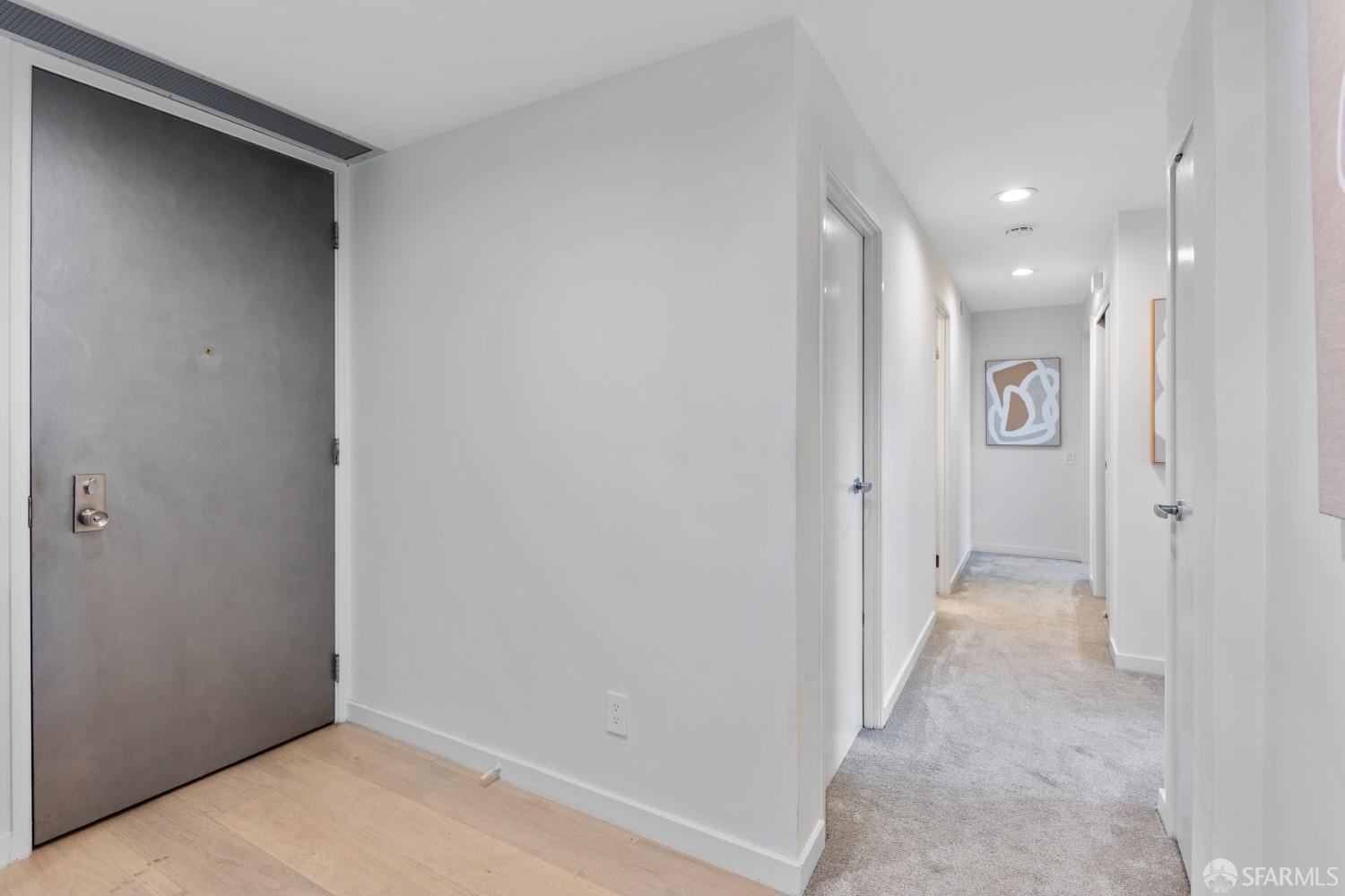 50 Mounds Road, Unit 404 San Mateo, CA 94402 - Photo 13 of 23 a view of a hallway with wooden floor and a bathroom