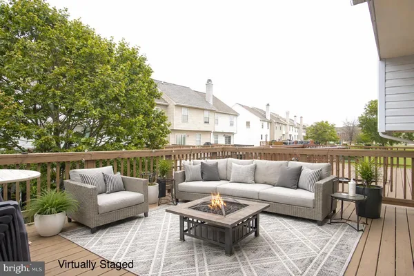 a view of a deck with wooden floor and barbeque oven
