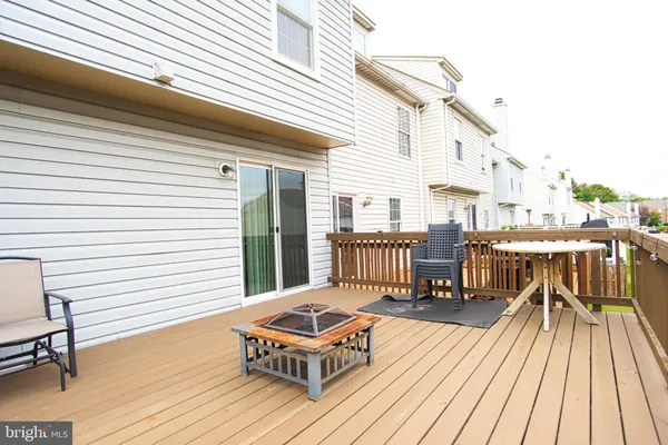 a balcony with wooden floor and furniture