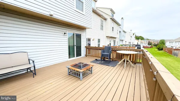 a view of balcony with wooden floor and seating space
