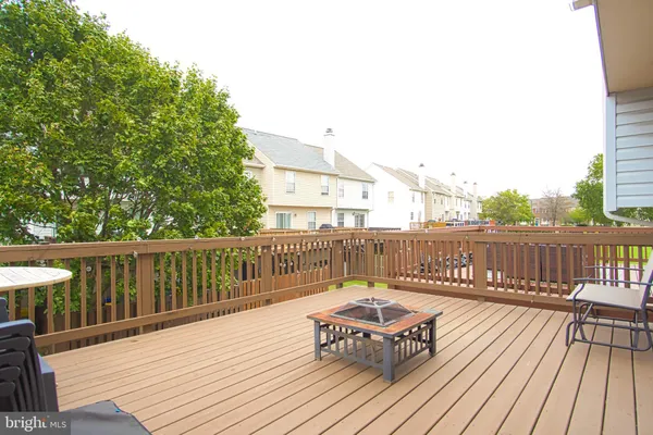 a balcony with wooden floor table and chairs