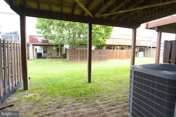 a view of a backyard with a small cabin and a chair