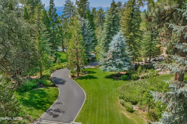 a view of a dining room with furniture a chandelier and wooden floor