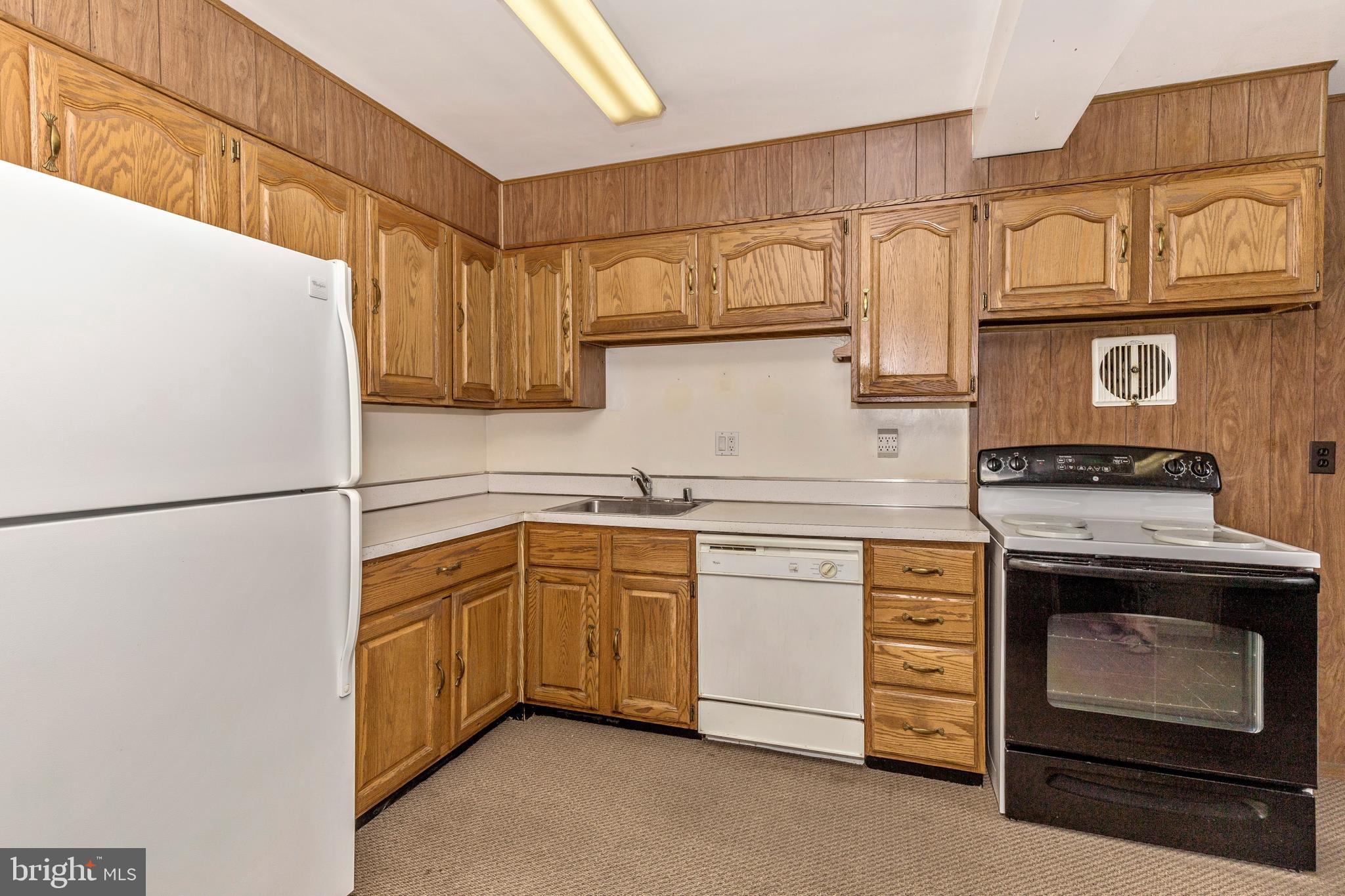 3929 Weller Road Silver Spring, MD 20906 - Photo 12 of 54 a kitchen with stainless steel appliances granite countertop a sink stove and refrigerator