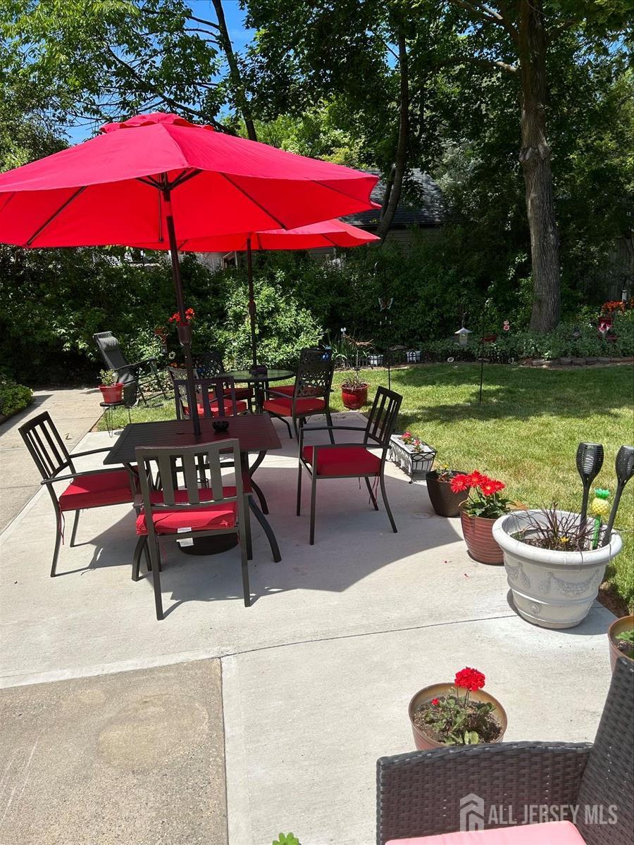 33 Ellison Road Somerset, NJ 08873 - Photo 26 of 38 a view of a patio with table and chairs under an umbrella