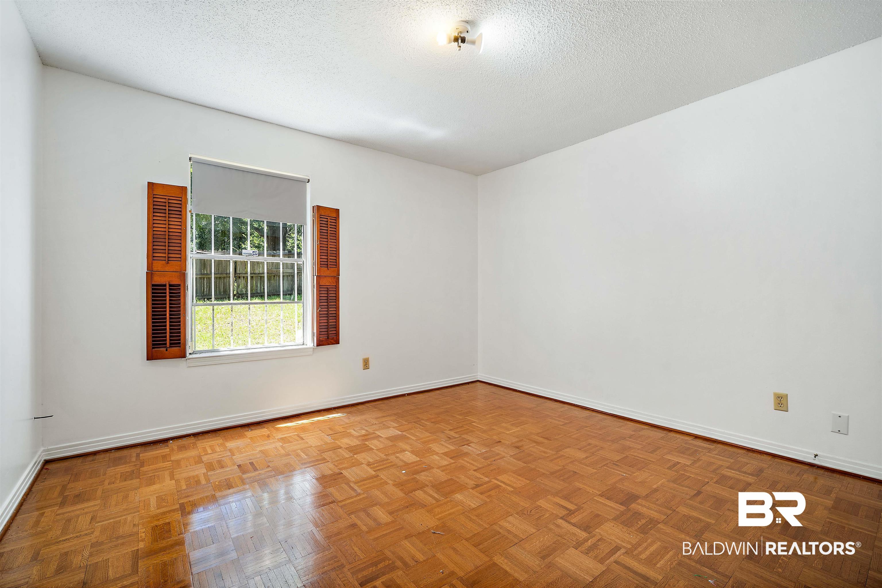 5559 Woodside Drive North Mobile, AL 36608 - Photo 14 of 28 Empty room featuring a textured ceiling and baseboards