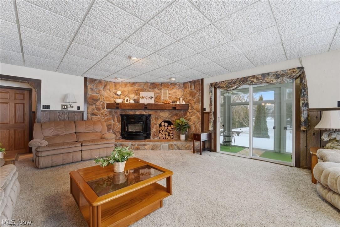 17452 Huntley Road Windsor, OH 44099 - Photo 11 of 49 Carpeted living room featuring a drop ceiling