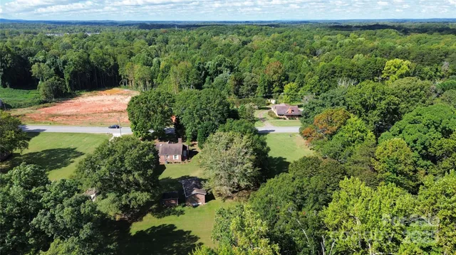 a backyard of a house with a yard and outdoor seating