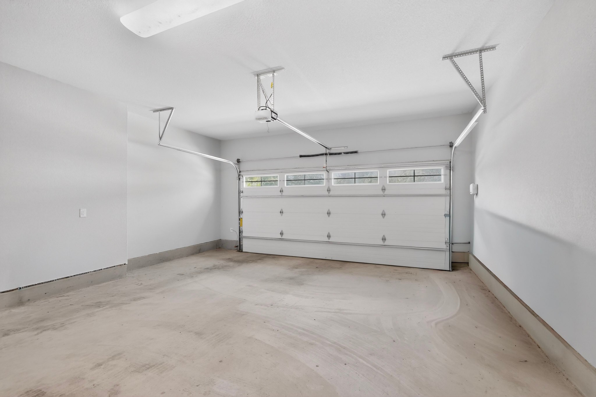 2605 Sam Bass Road, Unit 9 Round Rock, TX 78681 - Photo 31 of 38 A spacious, pristine garage ready for vehicles or extra storage.