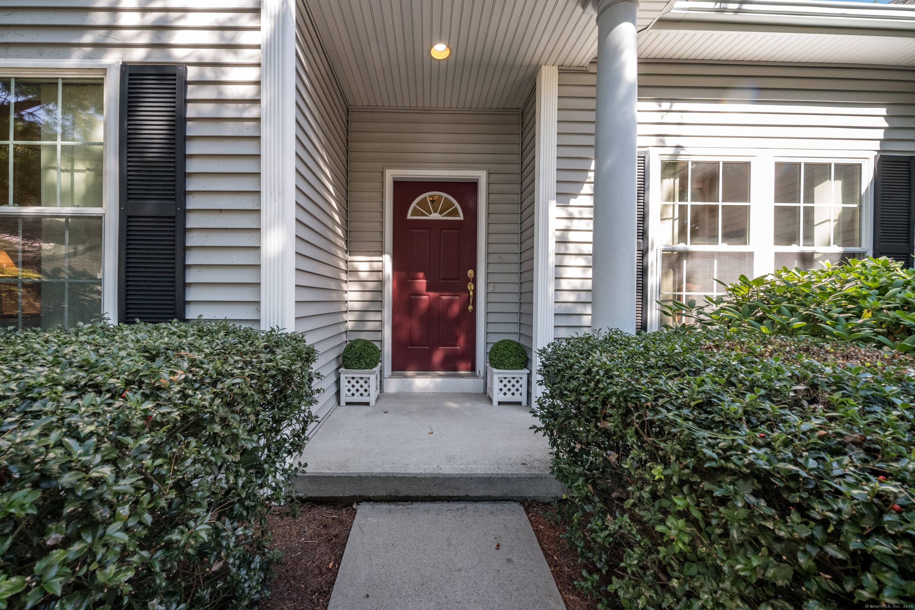 175 Ferry Road, Unit 10 Old Saybrook, CT 06475 - Photo 1 of 1 a view of a house with potted plants