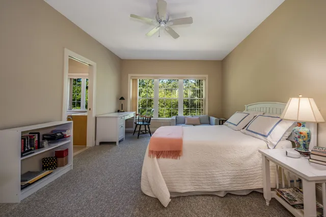 a bedroom with a bed and a large window