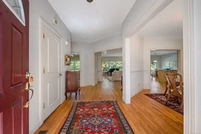 a view of a hallway view with wooden floor and a bedroom