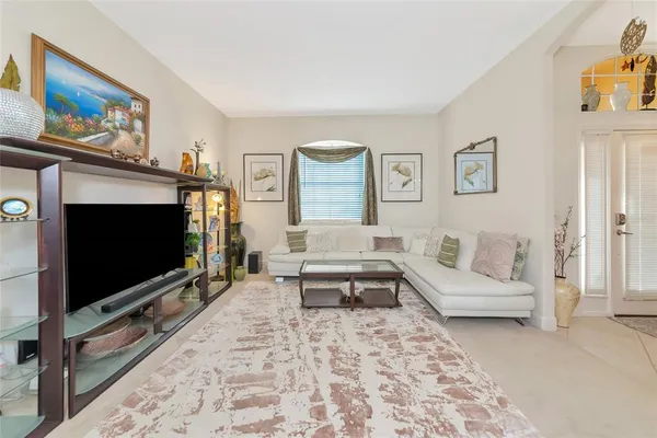 a dining room with furniture a chandelier and window